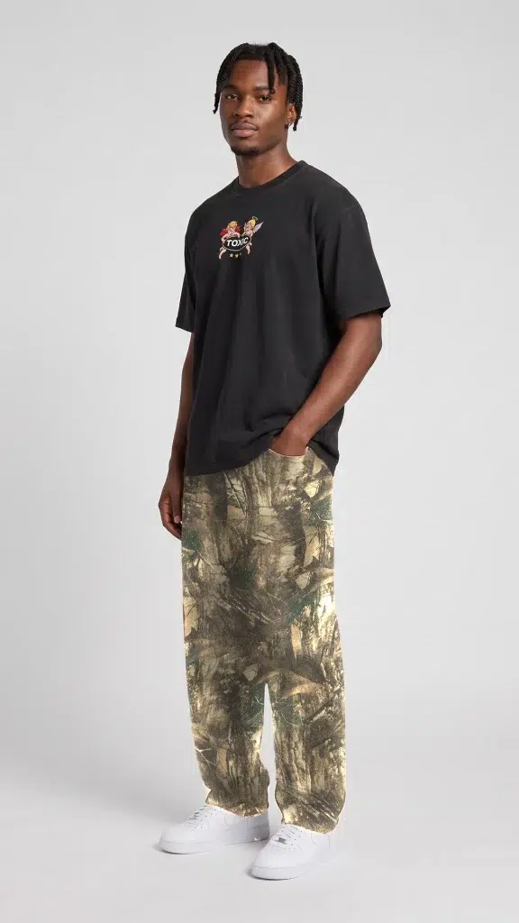 Side view of man wearing tree camo barrel leg pants