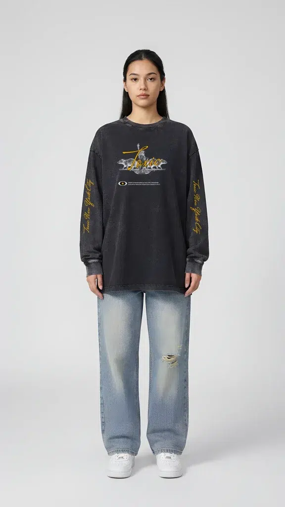 Woman wearing the Toxic NYC Liberty Curse Snow Washed Long Sleeve T-Shirt with light blue baggy jeans