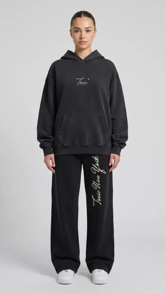 Woman wearing the Toxic NYC Script Vintage Wash Raw Edge Hoodie and the matching Script Vintage Wash Raw Edge Sweatpants